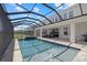 Screened-in pool and hot tub area with outdoor lounge seating and water feature at 4423 Pond Brook Ct, Bradenton, FL 34211
