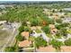 Aerial view of a residential neighborhood with tree-lined streets and a lake nearby at 5108 26Th Street W Ct, Bradenton, FL 34207
