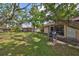 Backyard featuring mature trees, a grill, and enclosed porch at 5108 26Th Street W Ct, Bradenton, FL 34207