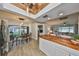 Kitchen with stainless steel fridge and butcher block island leading to dining room and living room area at 5108 26Th Street W Ct, Bradenton, FL 34207