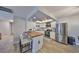 Bright kitchen with stainless steel appliances, white cabinetry, a butcher block island and unique lighting at 5108 26Th Street W Ct, Bradenton, FL 34207