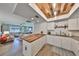 Well-lit kitchen with butcher block island, white cabinetry, and stainless appliances, open to a cozy living room at 5108 26Th Street W Ct, Bradenton, FL 34207