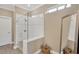 This bathroom showcases a walk-in shower with glass door, neutral tile, and a decorative mirror at 5128 Dockyard Pl, Land O Lakes, FL 34638