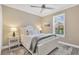 Bright bedroom featuring a white-framed bed, and cool-toned accent blanket and pillows at 5128 Dockyard Pl, Land O Lakes, FL 34638