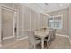 Elegant dining room with modern lighting, wainscoting, and seating for eight at 5128 Dockyard Pl, Land O Lakes, FL 34638
