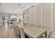 Bright dining room features a large table, stylish chairs, and an open view to the modern kitchen at 5128 Dockyard Pl, Land O Lakes, FL 34638
