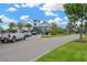 Community entrance gate with a modern design, lush landscaping, and controlled access for residents' security at 5128 Dockyard Pl, Land O Lakes, FL 34638