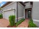 Home's exterior showcases a paved walkway, manicured bushes, and a welcoming entrance at 5128 Dockyard Pl, Land O Lakes, FL 34638