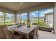 A patio with a dining table set and comfortable seating with a great view of the grassy lawn and outdoor structure at 5128 Dockyard Pl, Land O Lakes, FL 34638