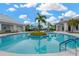 This pool features a center island with a palm tree for a tropical and visually appealing recreational space at 5128 Dockyard Pl, Land O Lakes, FL 34638