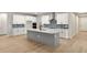Kitchen with white cabinetry, stainless steel appliances, and a large center island at 5322 124Th E Ave, Parrish, FL 34219