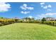 Large, well-manicured backyard with a black metal fence at 5601 Limelight Dr, Apollo Beach, FL 33572