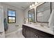 Modern bathroom with double vanity, quartz countertops, and stylish black-framed mirrors at 5601 Limelight Dr, Apollo Beach, FL 33572
