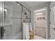 Bathroom with glass enclosed shower and open doorway leading to a walk-in closet at 5601 Limelight Dr, Apollo Beach, FL 33572