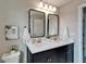 Bathroom features a double sink vanity, modern fixtures and framed mirrors at 5601 Limelight Dr, Apollo Beach, FL 33572