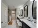 Bright bathroom featuring double vanity with modern sinks, mirrors, and a glass shower with an open doorway to a walk-in closet at 5601 Limelight Dr, Apollo Beach, FL 33572