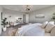 Bright, carpeted bedroom featuring neutral walls, elegant decor, and a comfortable seating area at 5601 Limelight Dr, Apollo Beach, FL 33572