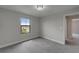 Empty bedroom with gray carpet and a window with a view of the neighborhood at 5601 Limelight Dr, Apollo Beach, FL 33572