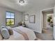 This bedroom boasts natural light, a chandelier, and a calming gray color scheme at 5601 Limelight Dr, Apollo Beach, FL 33572
