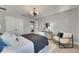 This bedroom boasts modern furniture, neutral walls, and a view into another bedroom at 5601 Limelight Dr, Apollo Beach, FL 33572