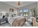 Bedroom with neutral colors, natural light, stylish decor, and outside views at 5601 Limelight Dr, Apollo Beach, FL 33572