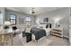 This neutral bedroom features plenty of sunlight, a fan, and minimalist décor at 5601 Limelight Dr, Apollo Beach, FL 33572