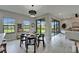 Bright dining area with a modern light fixture, large windows, and seamless transition to the living room at 5601 Limelight Dr, Apollo Beach, FL 33572