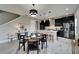 Eat-in kitchen with black cabinets, stainless appliances, large island and pendant lighting at 5601 Limelight Dr, Apollo Beach, FL 33572