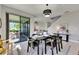 Bright dining area with backyard views, stylish decor, and seamless indoor-outdoor living at 5601 Limelight Dr, Apollo Beach, FL 33572