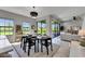Open dining area with contemporary lighting, easy access to the backyard, and comfortable seating at 5601 Limelight Dr, Apollo Beach, FL 33572