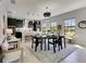 Modern dining area with pendant lighting, an open layout, and views of the backyard at 5601 Limelight Dr, Apollo Beach, FL 33572