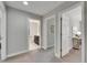 Neutral hallway showcasing access to a bathroom and other rooms within the home at 5601 Limelight Dr, Apollo Beach, FL 33572