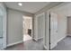Hallway with neutral walls, carpet and entryways to a bathroom and other rooms at 5601 Limelight Dr, Apollo Beach, FL 33572