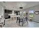 Open-concept kitchen with dark cabinetry, stainless steel appliances, and an adjacent dining area with backyard views at 5601 Limelight Dr, Apollo Beach, FL 33572