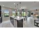 Modern kitchen with stainless steel appliances, a large island, and views of the backyard at 5601 Limelight Dr, Apollo Beach, FL 33572