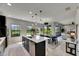 Well-lit kitchen showcasing an island with a sink, dining table, and access to the living room and outdoor views at 5601 Limelight Dr, Apollo Beach, FL 33572