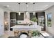 Modern kitchen with stainless steel appliances, quartz countertops, and an island with seating at 5601 Limelight Dr, Apollo Beach, FL 33572