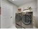 Well-lit laundry room with modern LG washer and dryer set and convenient shelving at 5601 Limelight Dr, Apollo Beach, FL 33572