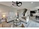 Spacious living room featuring contemporary decor, a stylish ceiling fan, and seamless transition to the kitchen at 5601 Limelight Dr, Apollo Beach, FL 33572