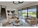 Open-concept living room with backyard view, modern lighting, and staircase access at 5601 Limelight Dr, Apollo Beach, FL 33572