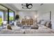 Inviting living room with elegant furniture, a modern ceiling fan, and a backyard view at 5601 Limelight Dr, Apollo Beach, FL 33572