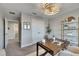 Bright, airy home office featuring a stylish desk, shelving, and comfortable seating at 5601 Limelight Dr, Apollo Beach, FL 33572