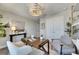 Cozy home office with a wooden desk, comfortable chairs, and bright, natural light at 5601 Limelight Dr, Apollo Beach, FL 33572