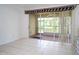 Bedroom with sliding doors to a screened lanai overlooking a serene water view, tile flooring throughout at 6507 Spring Oak Ct, Tampa, FL 33625