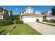 View of attached two-car garage, complemented by lush landscaping and a neatly maintained lawn at 6507 Spring Oak Ct, Tampa, FL 33625
