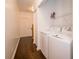 Convenient laundry area with modern appliances, added shelving, and easy access to nearby rooms at 6507 Spring Oak Ct, Tampa, FL 33625
