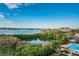 Scenic aerial view of the community with waterfront access, lush trees, pool, and serene waterfront at 7050 Sunset S Dr # 912, South Pasadena, FL 33707
