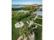 Breathtaking aerial view of lush landscaping, a sparkling pool, and a serene waterfront at 7050 Sunset S Dr # 912, South Pasadena, FL 33707