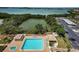 Aerial view of a pool with gazebos, lush landscaping, parking and bay view at 7050 Sunset S Dr # 912, South Pasadena, FL 33707