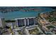 Fantastic aerial view of condo building near the water with plenty of parking and recreational facilities at 7050 Sunset S Dr # 912, South Pasadena, FL 33707